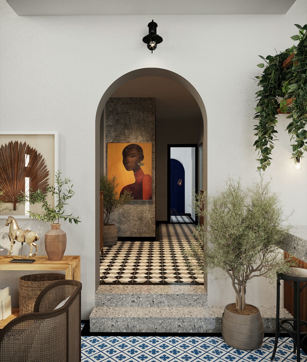 Entryway with an arched doorway, patterned tile floor, and a framed portrait beyond the threshold